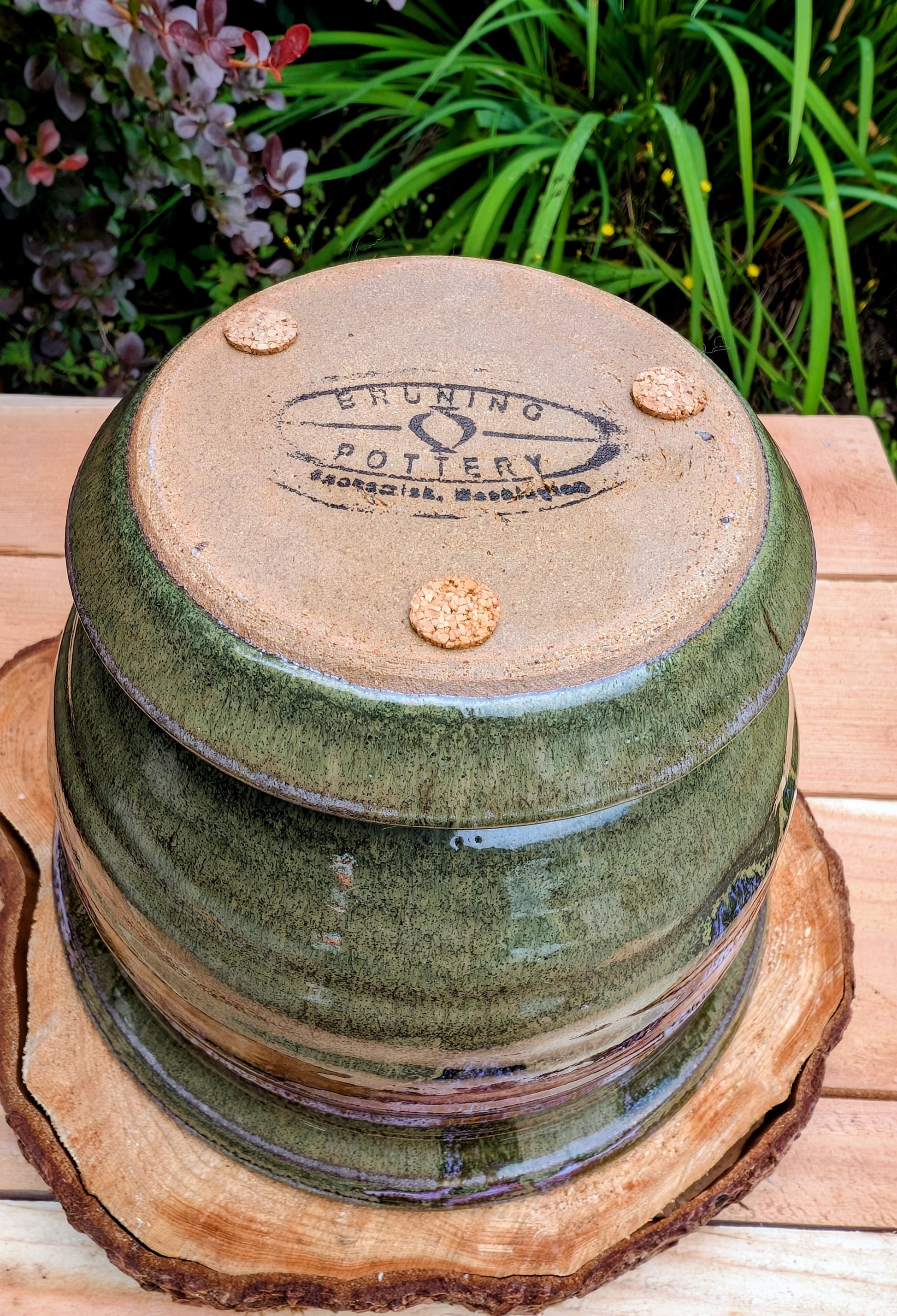 Handcrafted in Snohomish, Washington, this authentic Bruning Pottery stoneware planter showcases flowing moss green, olive, brown, and plum glazes inspired by the Pacific Northwest landscape. Complete with an integrated saucer, it's a beautiful and functional piece for houseplants, herbs, or succulent collections.