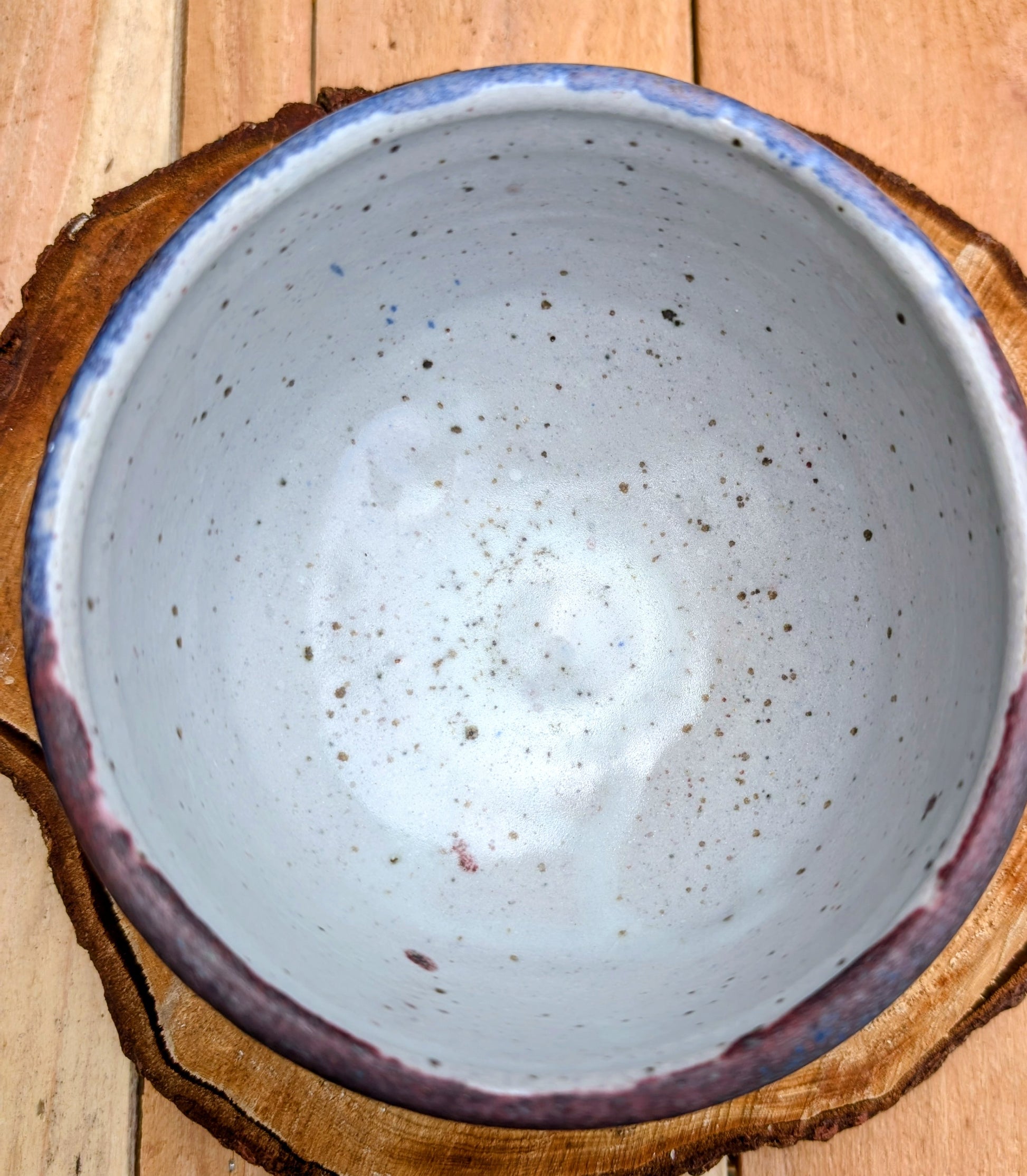 Bring handcrafted artistry to your home with this small footed studio pottery bowl featuring layered reactive glazes in purple, blue, charcoal, and earthy brown. Wheel-thrown from high-fired stoneware, its one-of-a-kind finish makes it equally beautiful as functional tableware or decorative art.