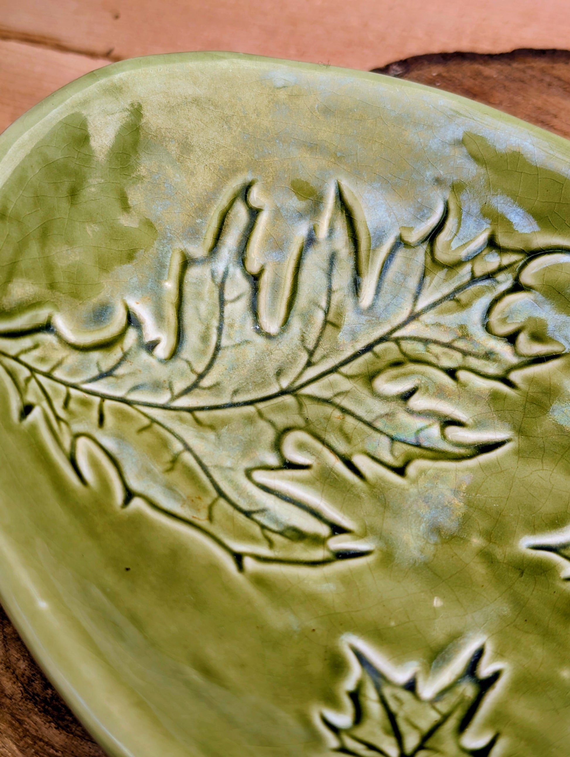 Celebrate the beauty of the forest with this handcrafted embossed oak leaf ceramic dish. Featuring a rich olive-green glaze and an organic form, it's equally at home serving small bites, holding jewelry, or adding a touch of Pacific Northwest charm to your décor.