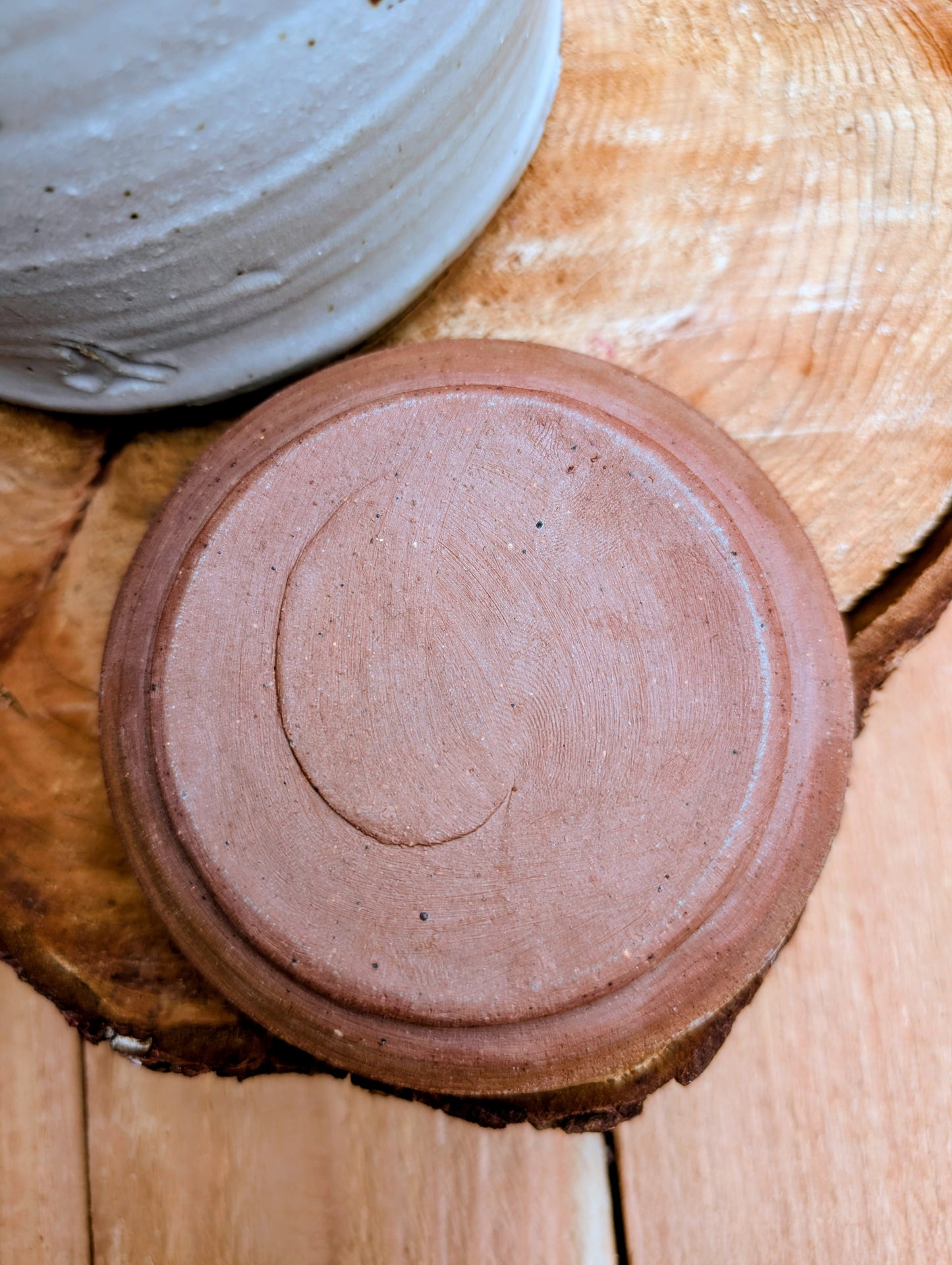 Bring warmth and handcrafted character to your kitchen with this wheel-thrown stoneware canister. Finished in a soft creamy-white glaze with subtle iron speckling, this timeless storage vessel blends rustic craftsmanship with modern organic design.