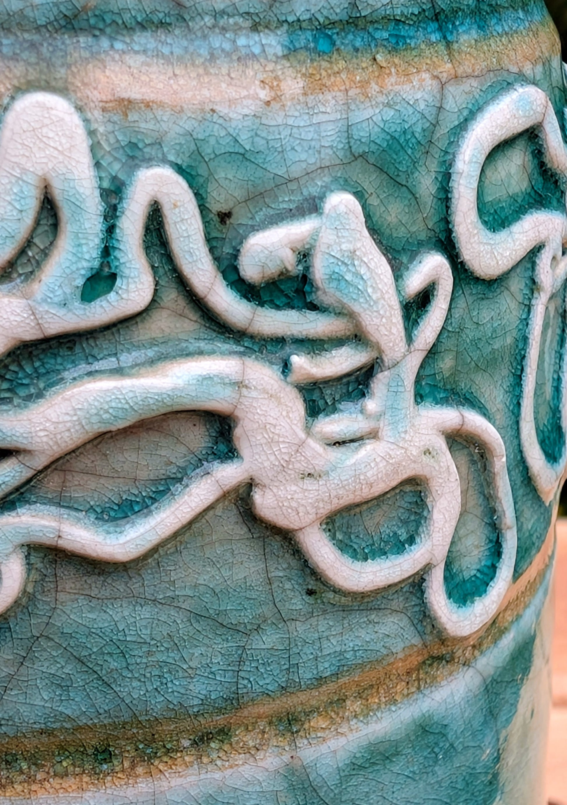 Celebrate the artistry of 1970s studio ceramics with this signed and dated handmade stoneware vase. Finished in a rich teal crackle glaze with distinctive white applied slip decoration, this sculptural piece brings timeless character to shelves, tables, and curated collections.