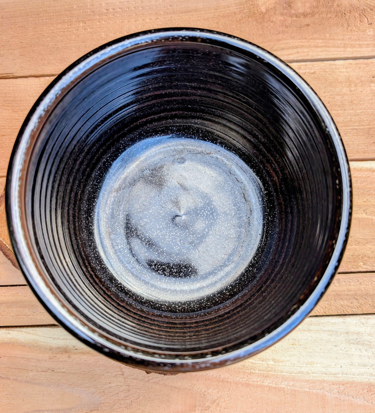 Bring the warmth of Pacific Northwest craftsmanship to your home with this authentic Bruning Pottery stoneware bowl from the studio's Seattle era. Featuring a rich iron-speckled glaze and wheel-thrown construction, it's equally beautiful as a serving bowl, planter cachepot, or decorative display piece.