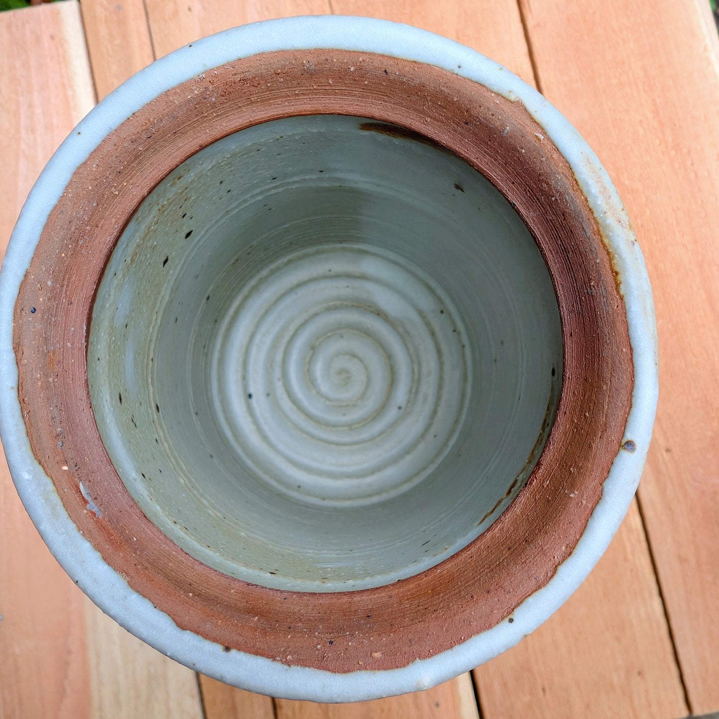 Bring warmth and handcrafted character to your kitchen with this wheel-thrown stoneware canister. Finished in a soft creamy-white glaze with subtle iron speckling, this timeless storage vessel blends rustic craftsmanship with modern organic design.