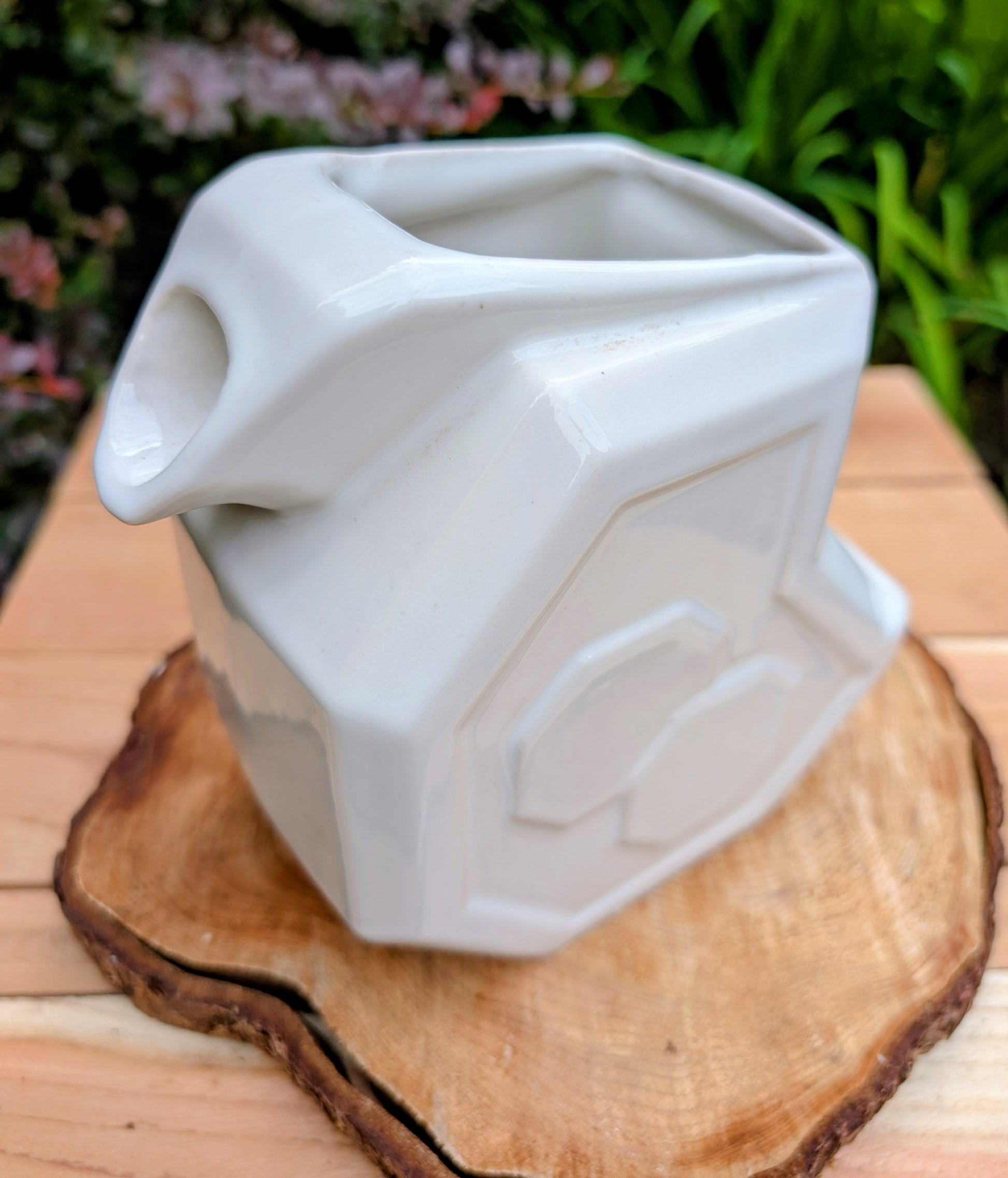 Bring timeless American Art Deco design into your home with this vintage Alamo Pottery Shape No. 758 pitcher. Its crisp geometric silhouette and glossy white glaze make it equally beautiful as a functional pitcher, sculptural vase, or decorative accent.