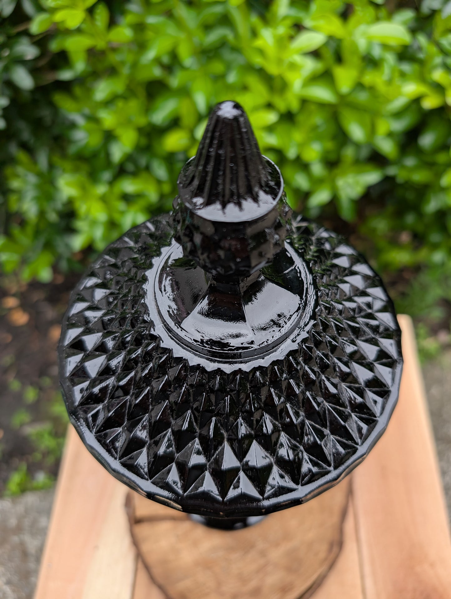 Make a dramatic statement with this vintage Tiara Exclusives Diamond Point covered pedestal compote in rich Cameo Black glass. Standing an impressive 16 inches tall, this elegant pressed glass piece is perfect for displaying wrapped candies, seasonal décor, ornaments, or treasured collectibles throughout the year.