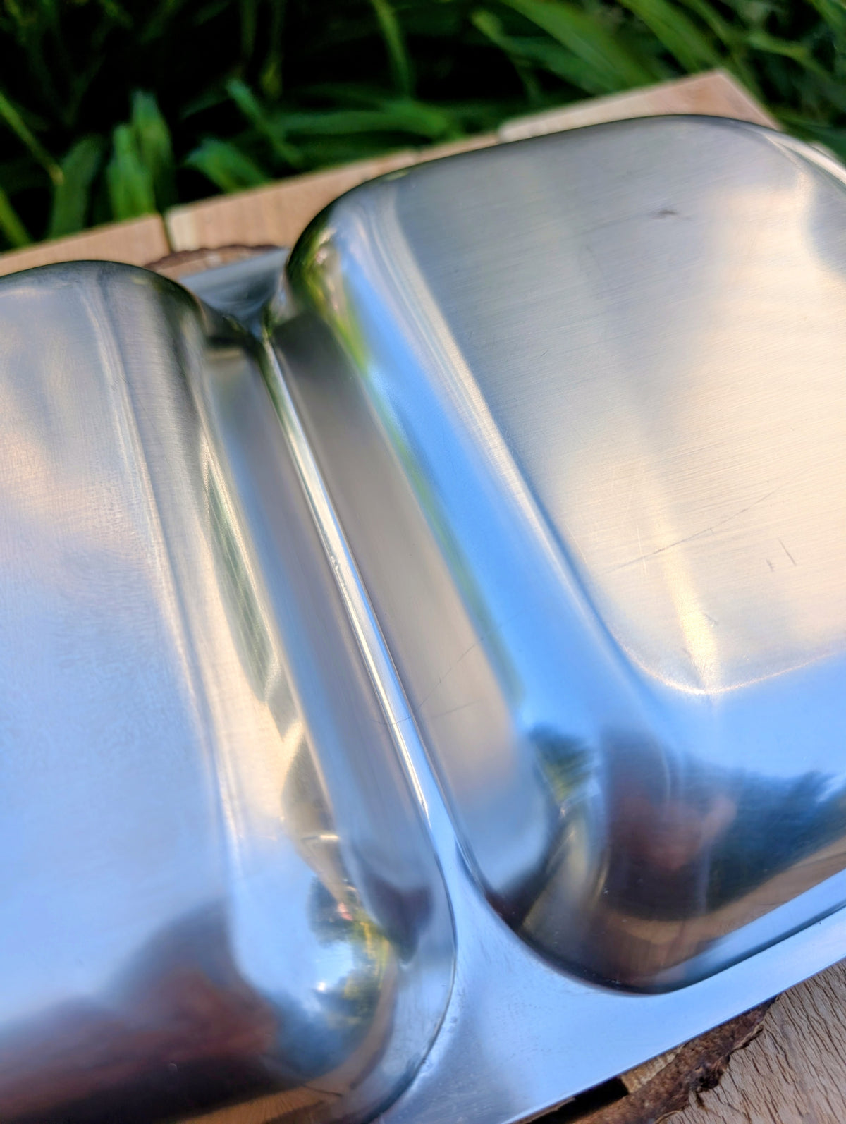 Invite a greater variety of backyard birds to your garden with this repurposed vintage stainless steel divided serving tray. Featuring two feeding compartments and warm wood handles, this one-of-a-kind piece combines timeless vintage style with practical bird-friendly function.