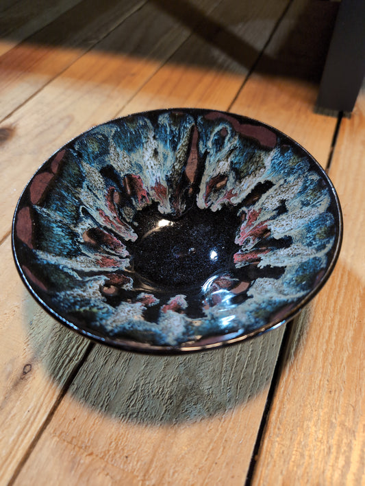 Small ceramic glazed dish. Black base with drip glaze in blue and pink thick base are assigned Pacific Northwest decor