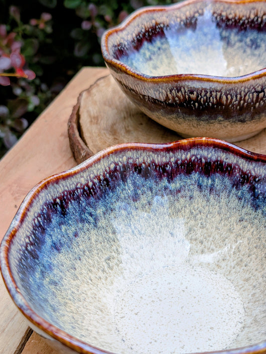 Bring understated elegance to everyday dining with this set of three RIRAKU stackable stoneware bowls. Featuring organically scalloped rims and beautifully layered reactive glazes inspired by traditional Japanese pottery, these versatile bowls are perfect for soups, rice, snacks, desserts, and small shared dishes.