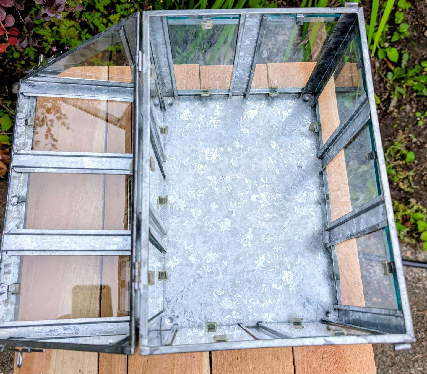 Bring the charm of a Victorian conservatory indoors with this decorative galvanized metal and glass tabletop greenhouse. Perfect for displaying succulents, moss gardens, candles, seasonal décor, or treasured collectibles, it adds timeless botanical style to any room.