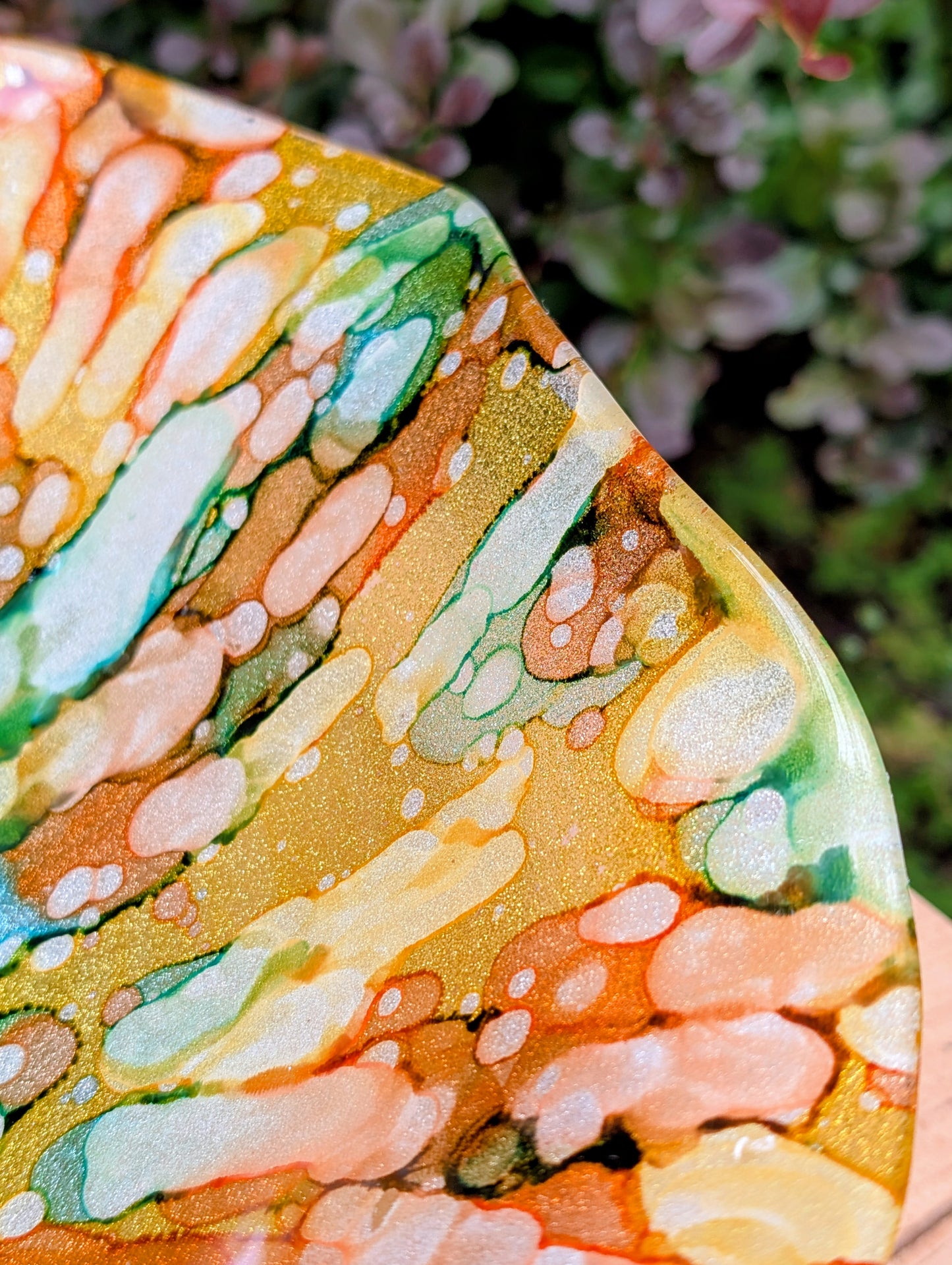 Bring color and light to your home or garden with this contemporary scalloped art glass bowl. Featuring warm golden tones accented by olive green, amber, turquoise, and shimmering metallic highlights, it serves beautifully as a centerpiece, decorative bowl, or tabletop bird bath.