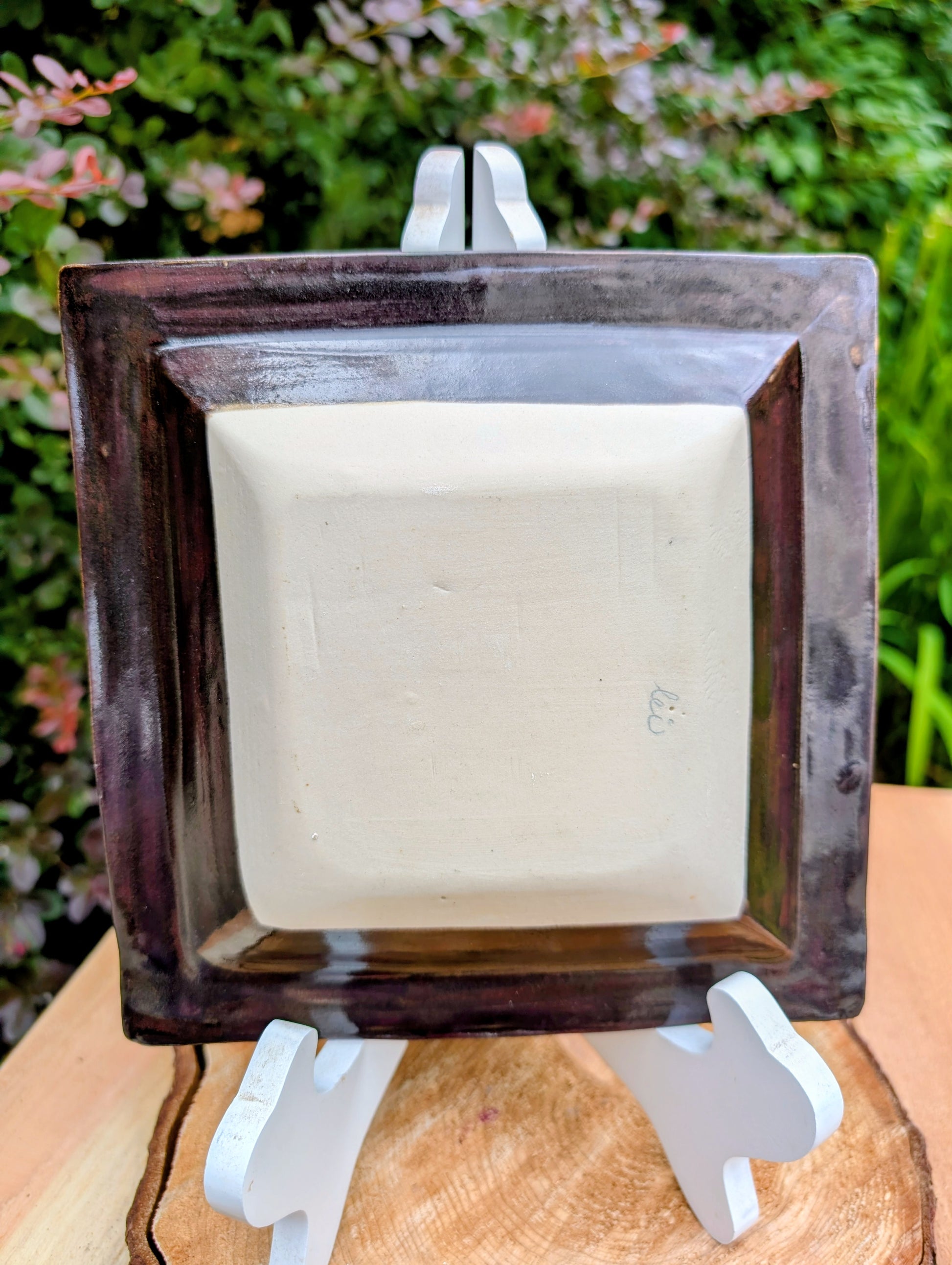 Celebrate the beauty of handcrafted ceramics with this square studio pottery dish featuring layered reactive glazes in rich chocolate brown, gray, olive, cream, and golden crystalline accents. Perfect as a catchall tray, jewelry dish, appetizer plate, or decorative accent, it brings organic warmth to any space.