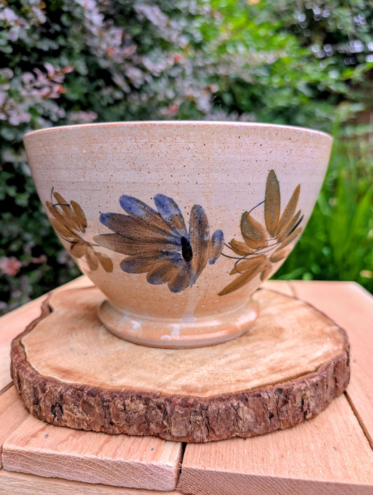 Bring warmth and handcrafted character to your home with this vintage hand-thrown terracotta footed bowl. Featuring a hand-painted floral motif and rich earthy tones, it serves beautifully as both functional serveware and timeless decorative pottery.