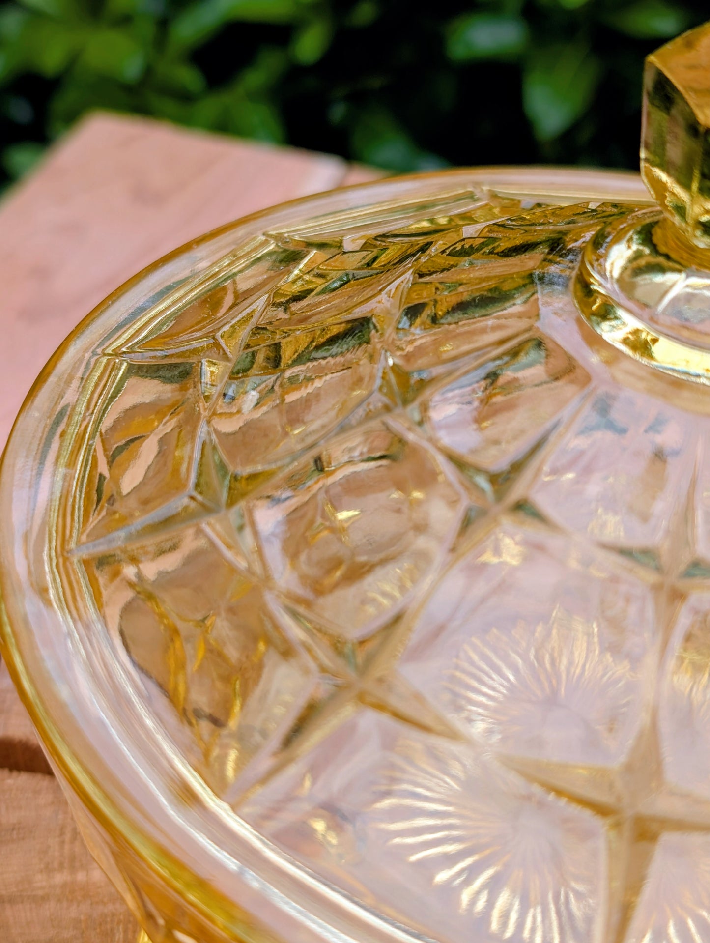 Bring warm vintage charm to your home with this beautiful Tiara Exclusives Constellation covered candy dish in the sought-after Yellow Mist color. Produced by Indiana Glass during the 1970s, its geometric star pattern and golden glow make it a timeless piece for entertaining or display.