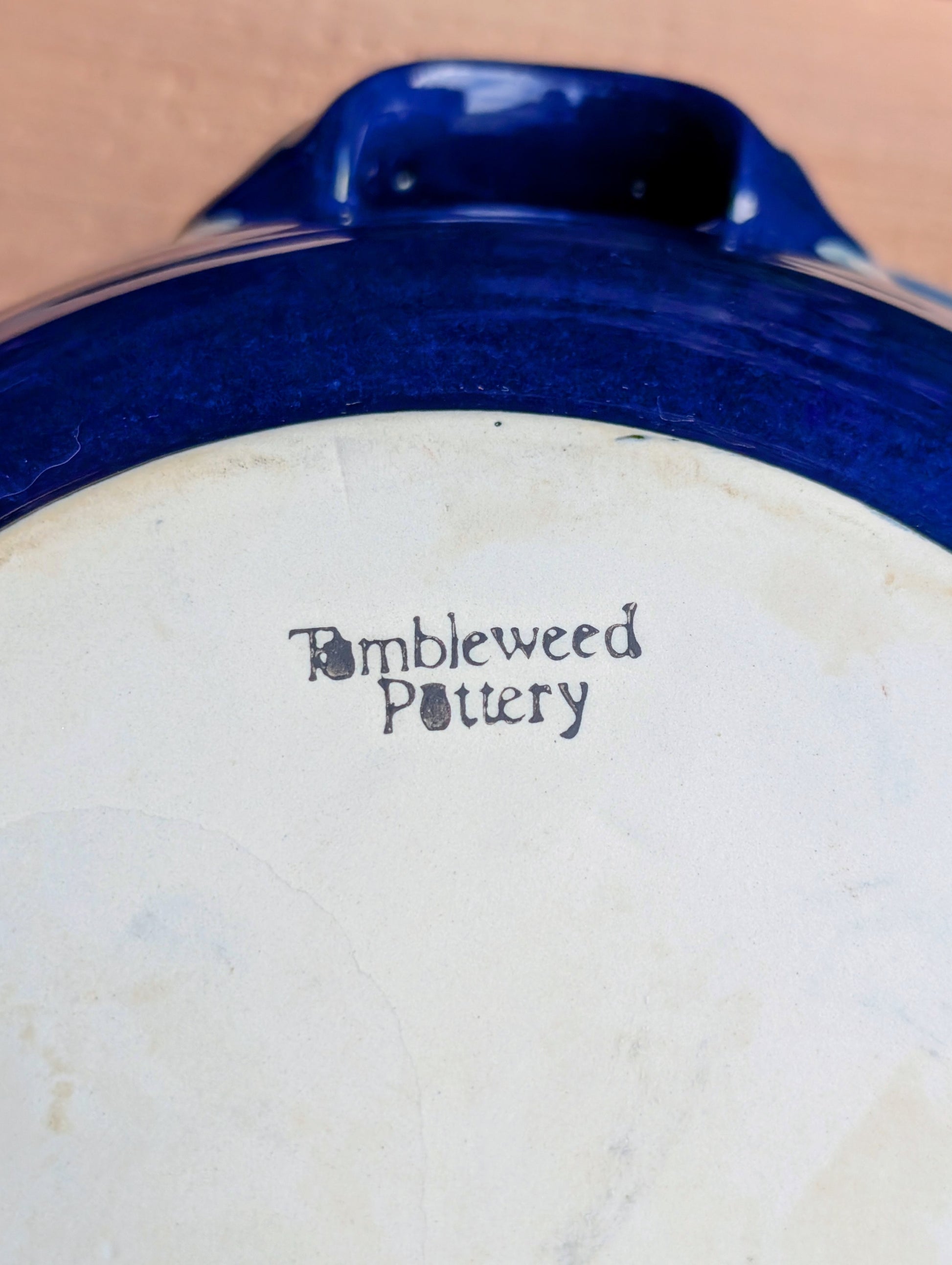 Bring handcrafted Southern stoneware into your kitchen with this vintage Tumbleweed Pottery Dixie Chicken Cooker. Designed to roast poultry upright for juicy, flavorful results, its vibrant cobalt blue glaze also makes it a beautiful serving and display piece when not in use.