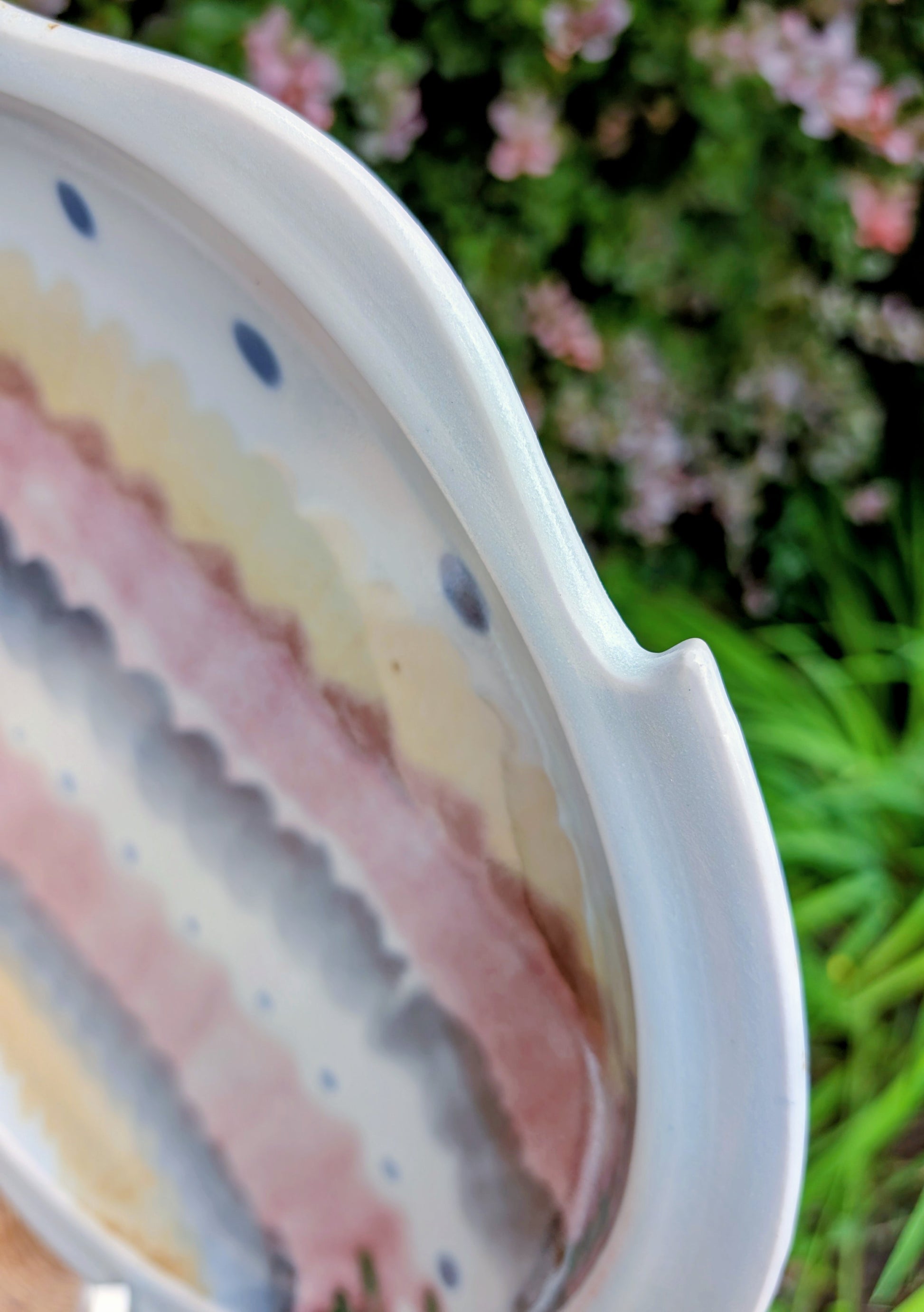 A beautifully handcrafted 14-inch studio pottery platter featuring layered abstract decoration in soft blue-gray, dusty pink, cream, and cobalt accents. Equally stunning as a serving piece or decorative display charger, this artisan-made platter brings timeless craftsmanship to modern living.