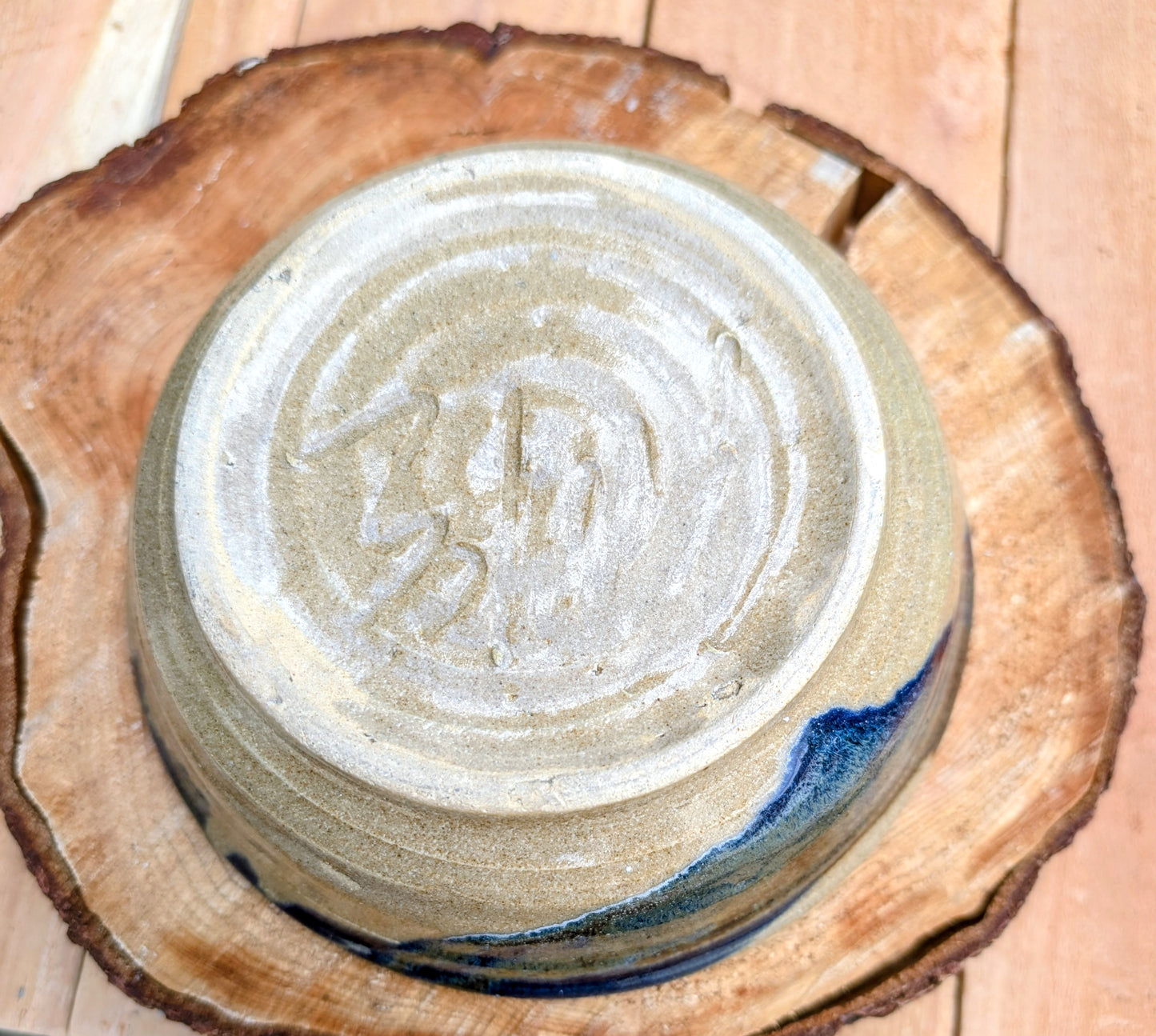 Bring handcrafted warmth to your table with this beautifully wheel-thrown studio pottery bowl, attributed to Gladstone Wear. Featuring flowing cobalt blue, charcoal, and earthy brown glazes over a natural buff stoneware body, it offers timeless artisan appeal for serving or display.