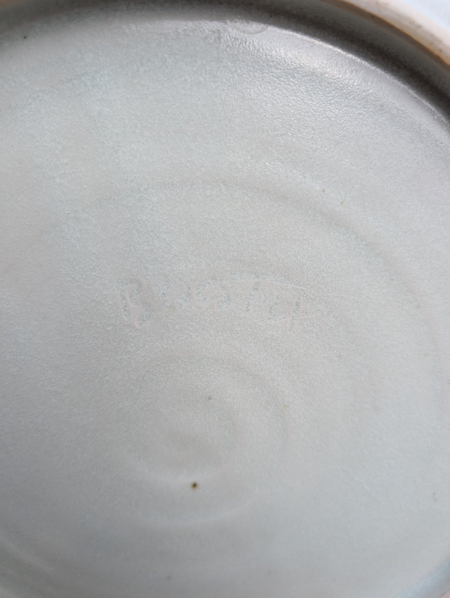 A beautifully handcrafted 14-inch studio pottery platter featuring layered abstract decoration in soft blue-gray, dusty pink, cream, and cobalt accents. Equally stunning as a serving piece or decorative display charger, this artisan-made platter brings timeless craftsmanship to modern living.