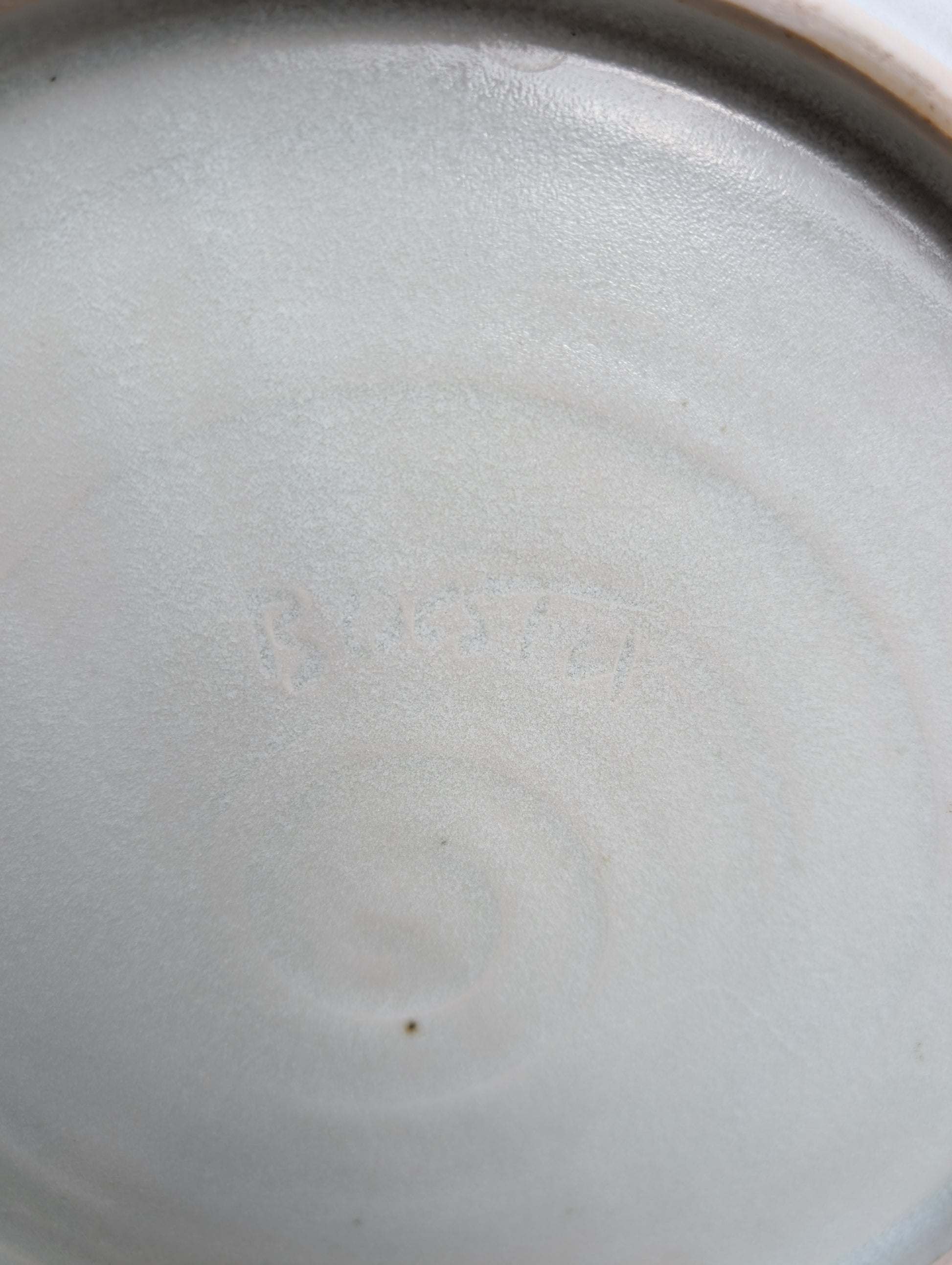 A beautifully handcrafted 14-inch studio pottery platter featuring layered abstract decoration in soft blue-gray, dusty pink, cream, and cobalt accents. Equally stunning as a serving piece or decorative display charger, this artisan-made platter brings timeless craftsmanship to modern living.