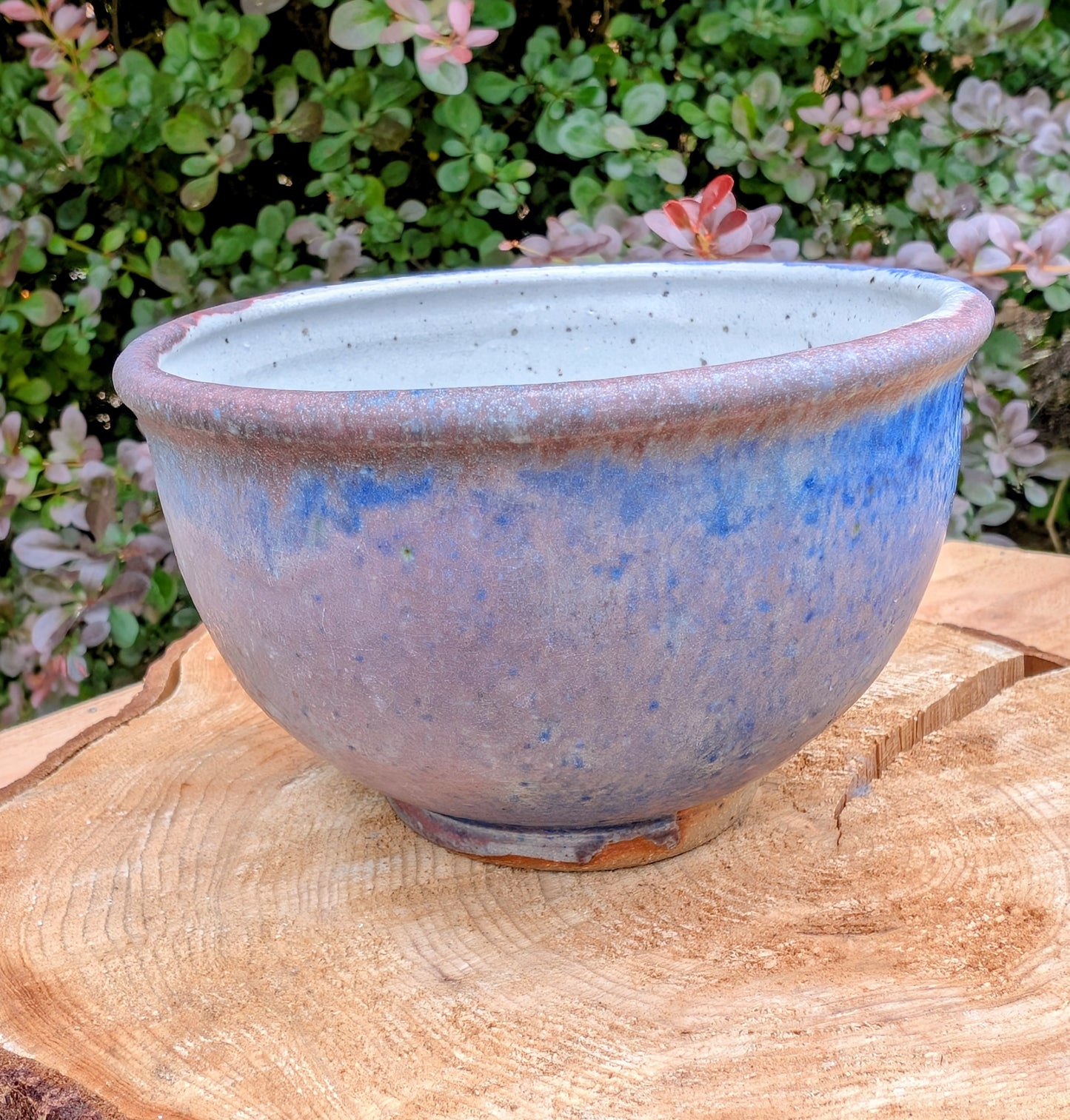 Bring handcrafted artistry to your home with this small footed studio pottery bowl featuring layered reactive glazes in purple, blue, charcoal, and earthy brown. Wheel-thrown from high-fired stoneware, its one-of-a-kind finish makes it equally beautiful as functional tableware or decorative art.
