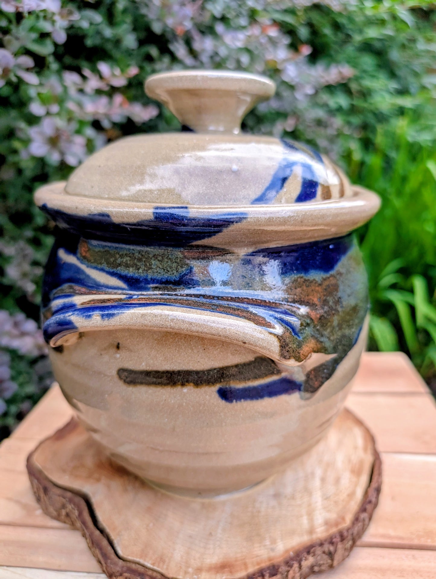 A beautifully handcrafted studio pottery tureen featuring a fitted lid, integrated handles, and a flowing cobalt blue glaze over warm oatmeal stoneware. Both functional and decorative, this artisan serving piece brings timeless craftsmanship and organic beauty to the table