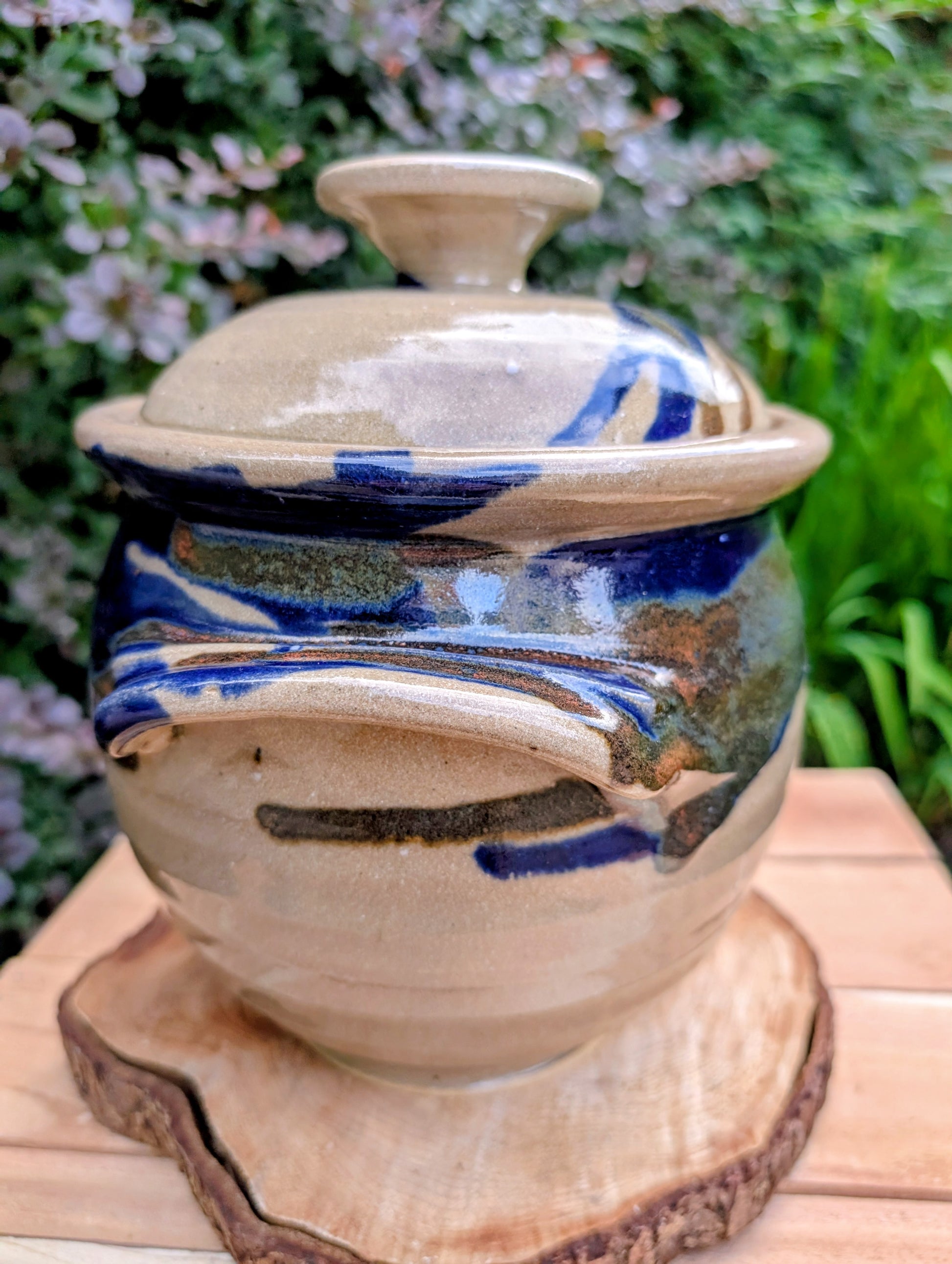 A beautifully handcrafted studio pottery tureen featuring a fitted lid, integrated handles, and a flowing cobalt blue glaze over warm oatmeal stoneware. Both functional and decorative, this artisan serving piece brings timeless craftsmanship and organic beauty to the table