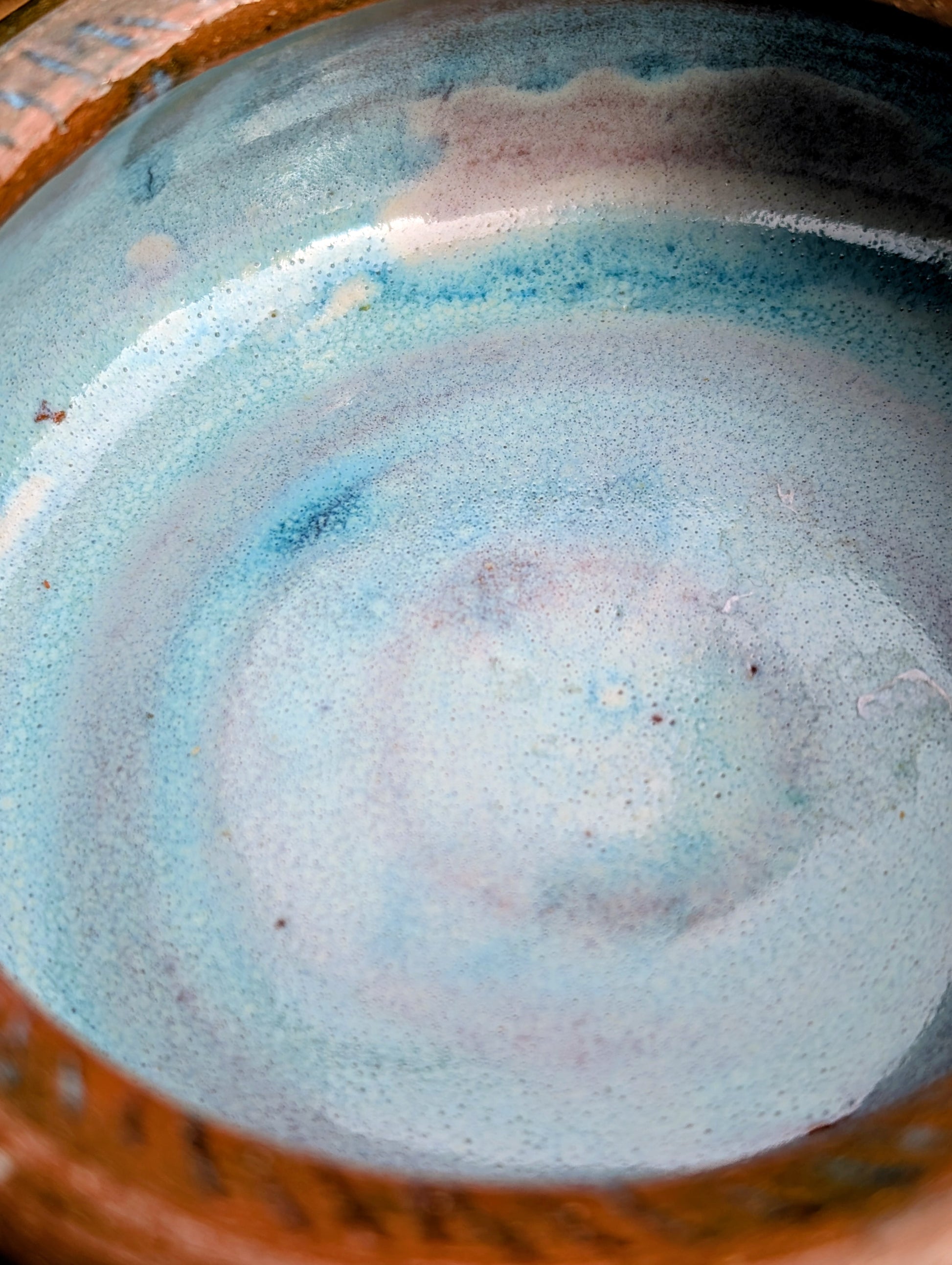 Handcrafted with richly carved texture and a soft blue reactive glaze, this signed studio pottery bowl brings warmth and character to any home. Ideal as a serving bowl, decorative accent, or functional piece of everyday artisan pottery.