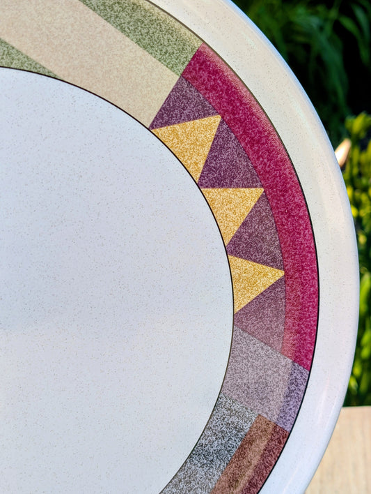Bring warm desert-inspired style to your table or home with this vintage Studio Nova Palm Desert serving platter, designed by Nancy Green in 1995. Its earthy geometric border and durable stoneware construction make it equally beautiful for entertaining, seasonal displays, or everyday décor.
