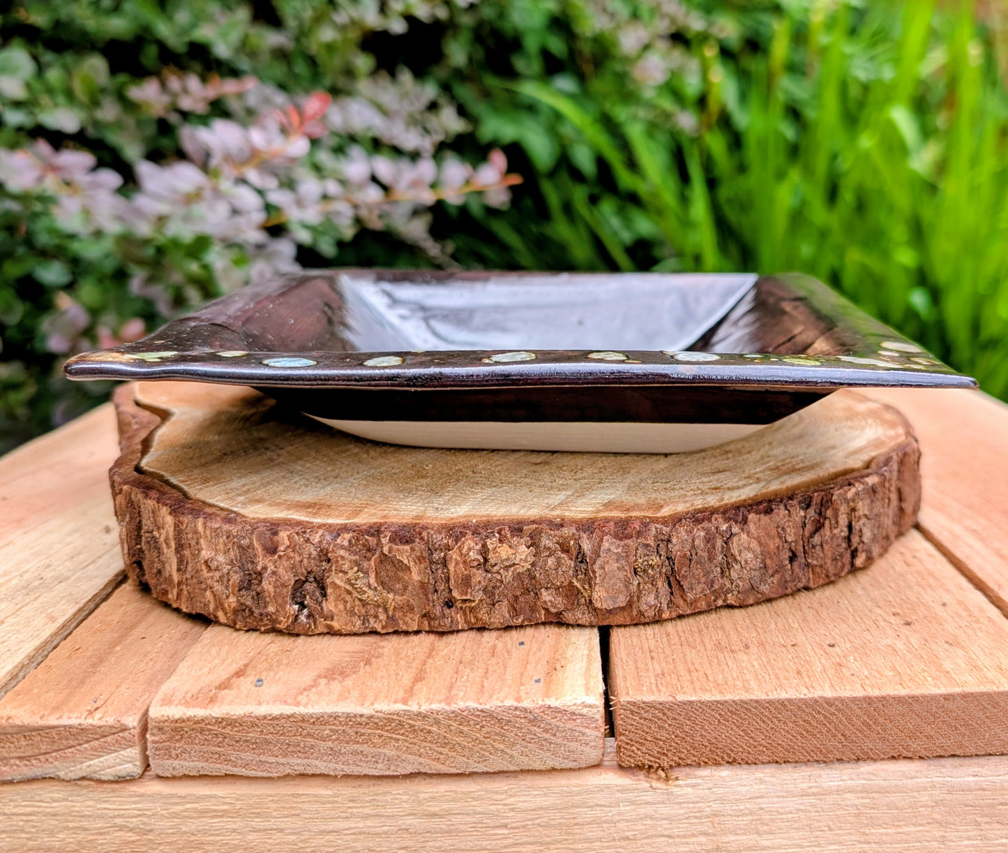 Celebrate the beauty of handcrafted ceramics with this square studio pottery dish featuring layered reactive glazes in rich chocolate brown, gray, olive, cream, and golden crystalline accents. Perfect as a catchall tray, jewelry dish, appetizer plate, or decorative accent, it brings organic warmth to any space.